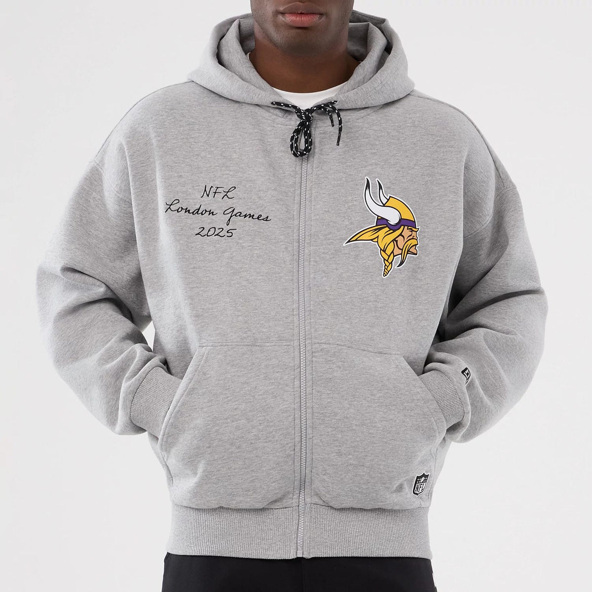 New Era Minnesota Vikings NFL International Series Games 2025 Grey Premium Pullover Hoodie, front view showing a embroidered Vikings logo on the chest, NFL London Games 2025 lettering on the left and a small New Era embroidered logo on the sleeve.
