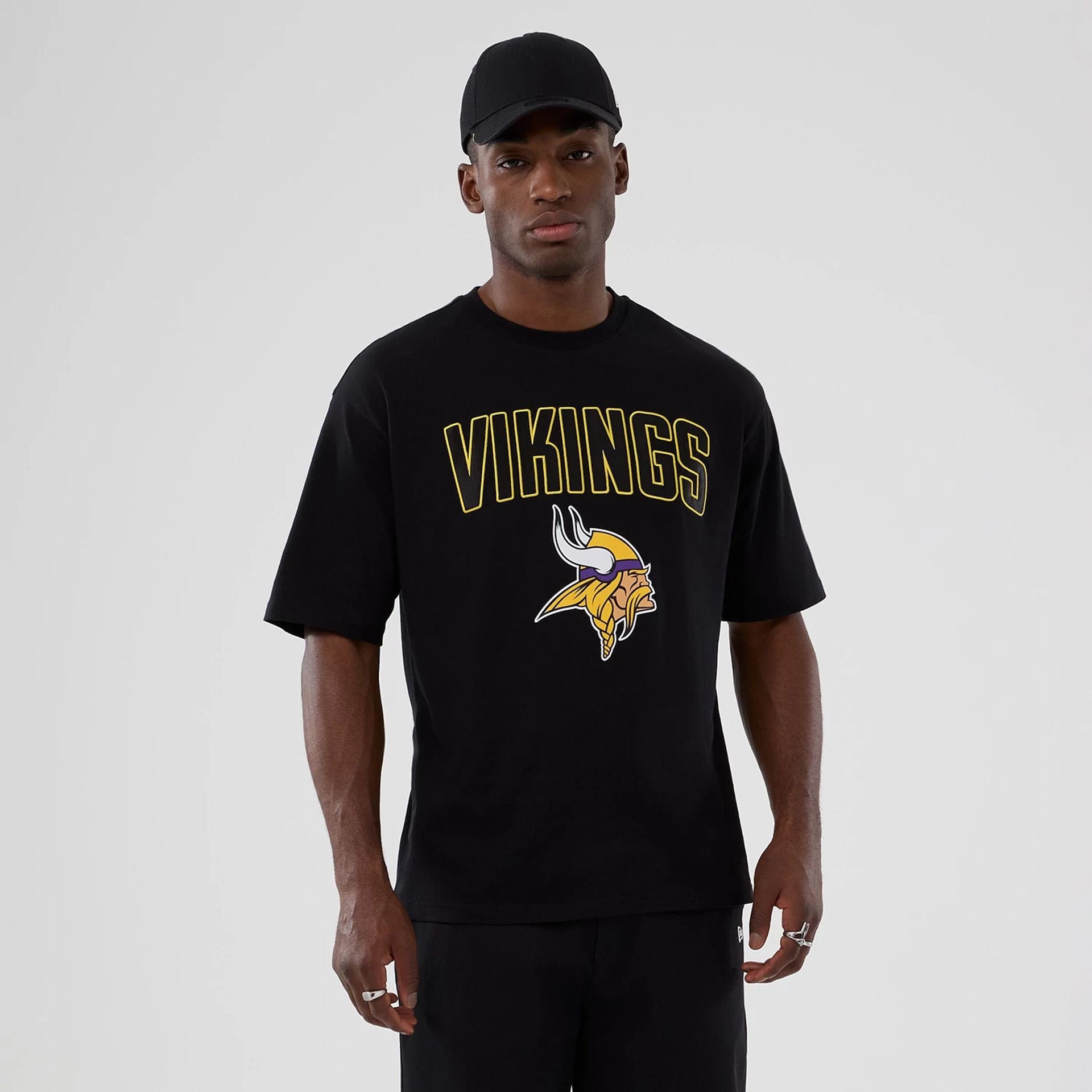The Male model is wearing Minnesota Vikings NFL International Series Games 2025 Black Premium T-Shirt 1