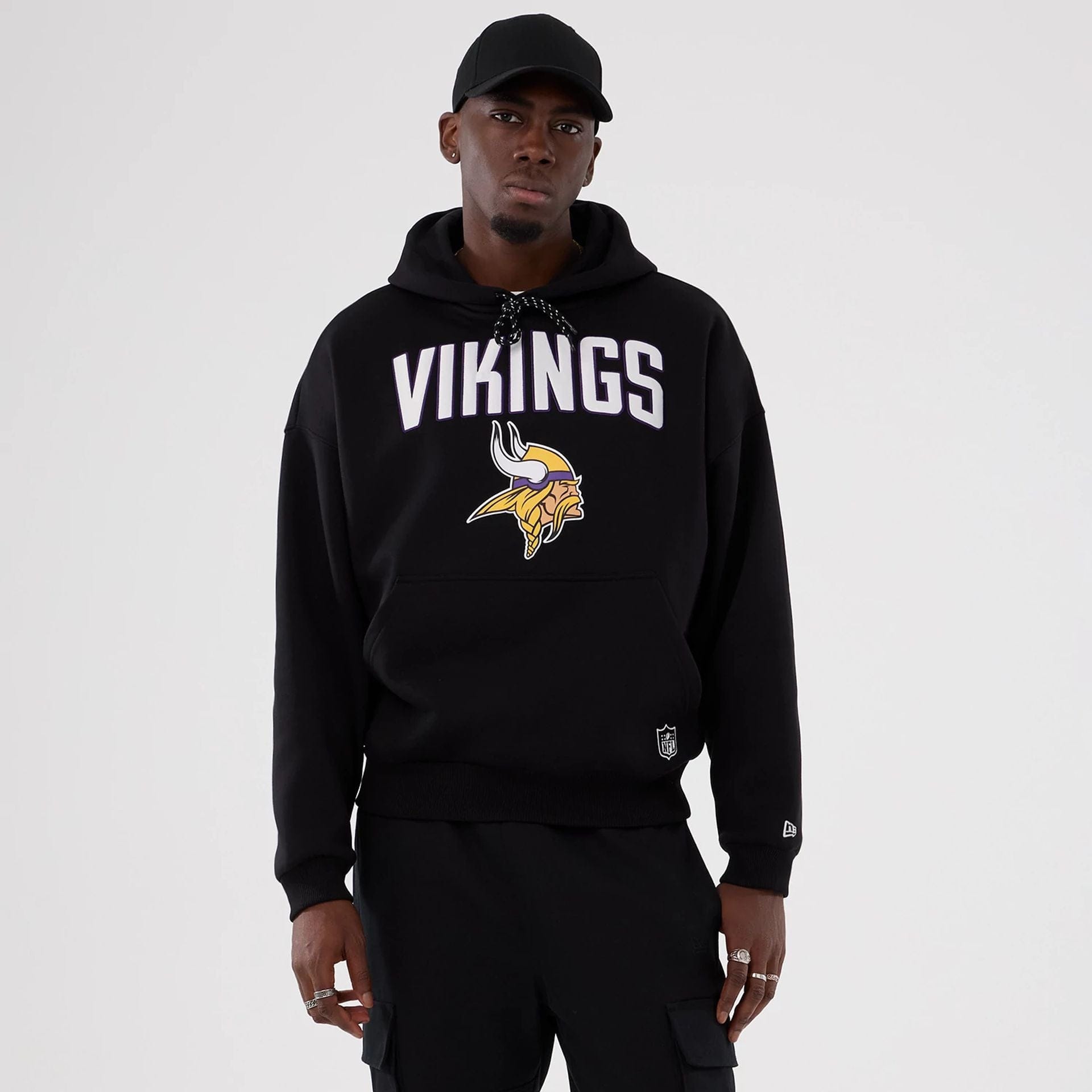 The Male model is wearing Minnesota Vikings NFL International Series Games 2025 Black Premium Pullover Hoodie 1