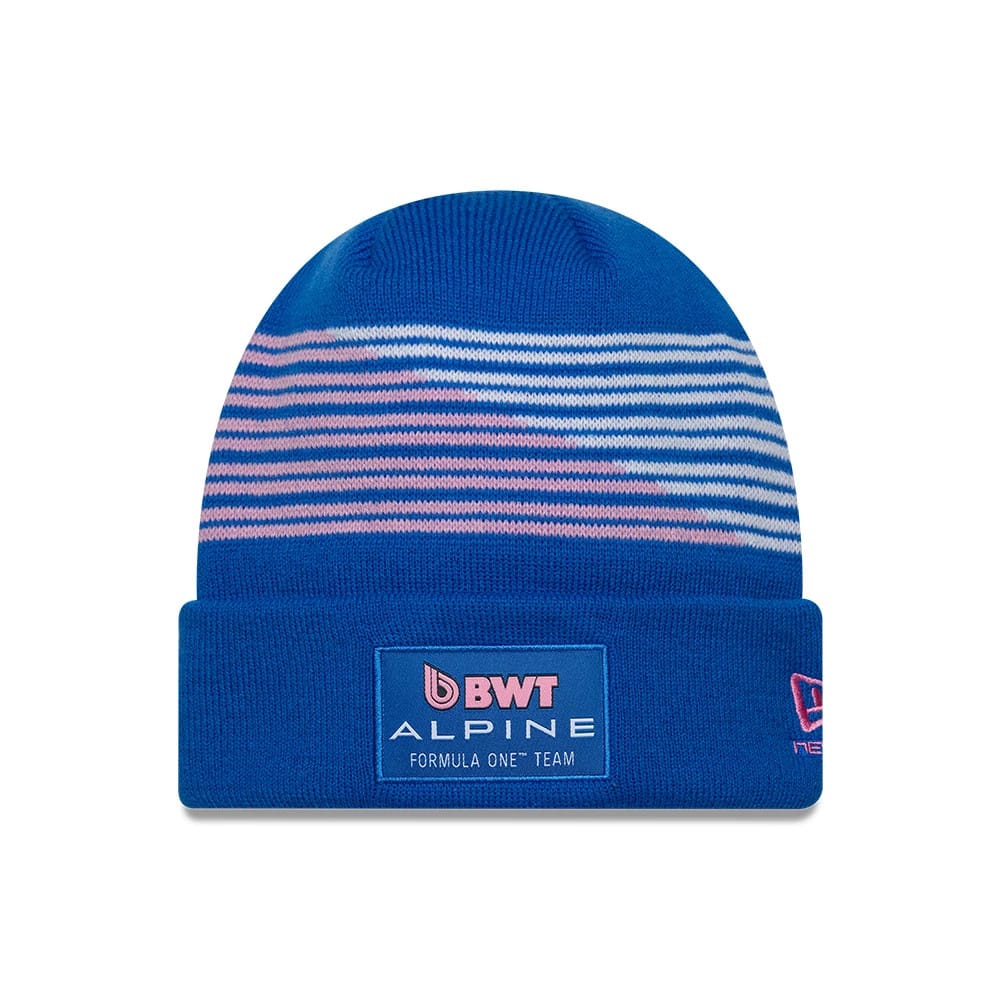 New Era Alpine Racing Blue Cuff Knit Beanie Hat, front view showing the BWT Alpine Formula One Team patch centrally on the blue cuff, with pink and white horizontal stripe pattern above and New Era flag logo on the right side.