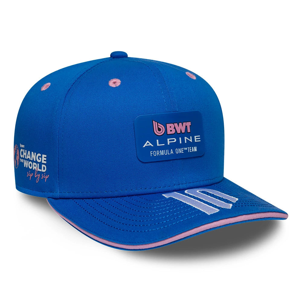 Alpine Racing Pierre Gasly Blue New Era 9SEVENTY Stretch Snap Adjustable Cap, three-quarter view showing the BWT Alpine Formula 1 Team patch on the front panel, pink eyelets, and number 10 embroidered on the blue visor with pink edging.