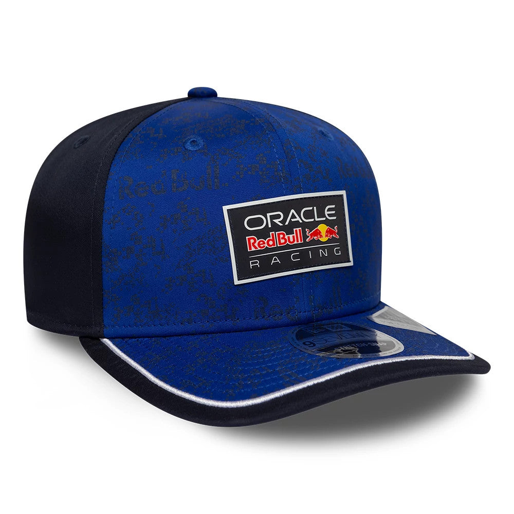 Red Bull Racing Team Dark Blue New Era 9SEVENTY Stretch Snap Adjustable Cap, three-quarter view showing the embroidered Oracle Red Bull Racing patch on the structured dark blue front panel with a curved black visor featuring a 9SEVENTY size sticker.