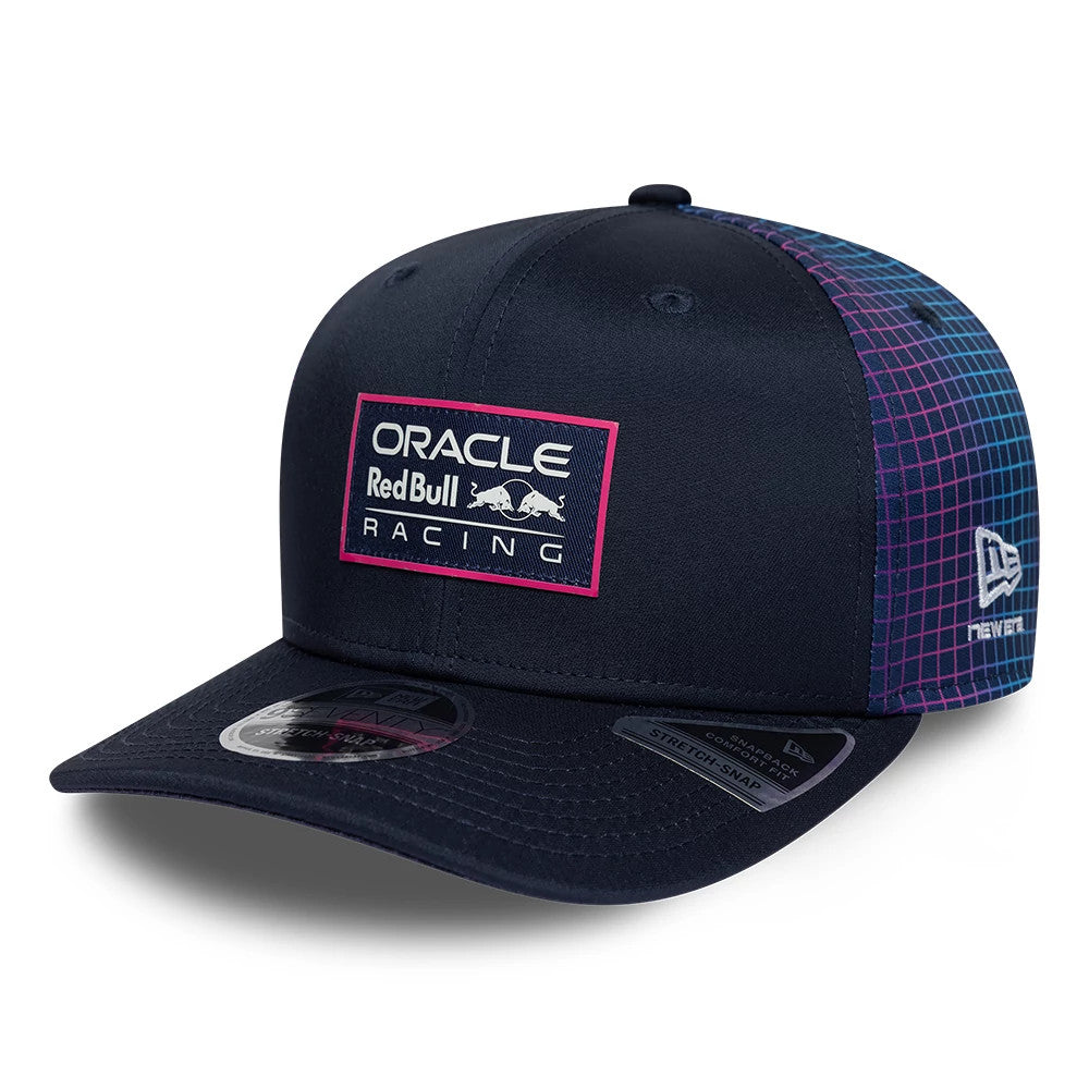 Red Bull Racing Miami Race Special Navy New Era 9SEVENTY Stretch Snap Adjustable Cap, three-quarter view showing a white and pink embroidered Oracle Red Bull Racing logo on the front and a grid pattern on the side with the New Era flag logo.