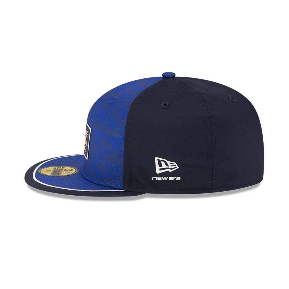 Red Bull Racing Dark Blue New Era 59FIFTY Fitted Cap, side view showing the white New Era flag logo embroidered on the left side, a structured dark blue crown, and a contrasting gold 59FIFTY size sticker on the flat visor.