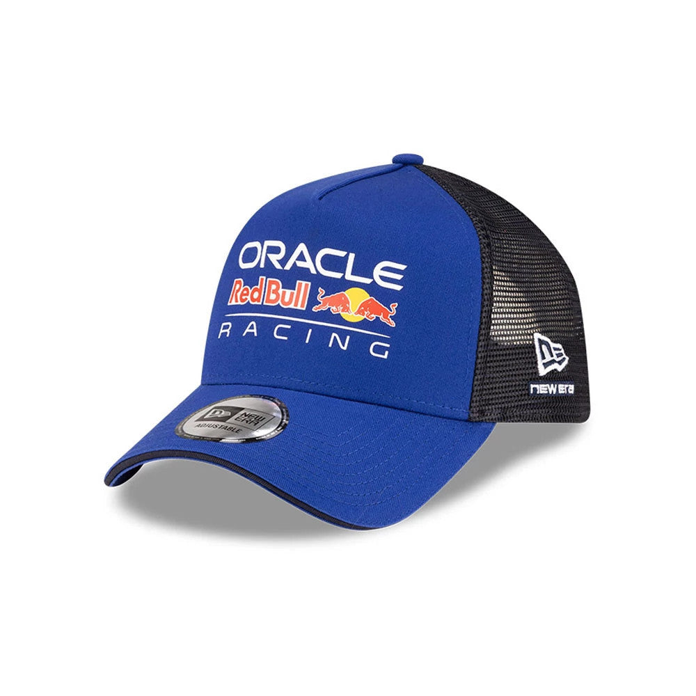 Red Bull Racing Essential Dark Blue New Era 9FORTY A-Frame Trucker Adjustable Cap, three-quarter view showing the Oracle Red Bull Racing logo in white and red on the front panel, with a curved blue visor and 9FORTY size sticker.