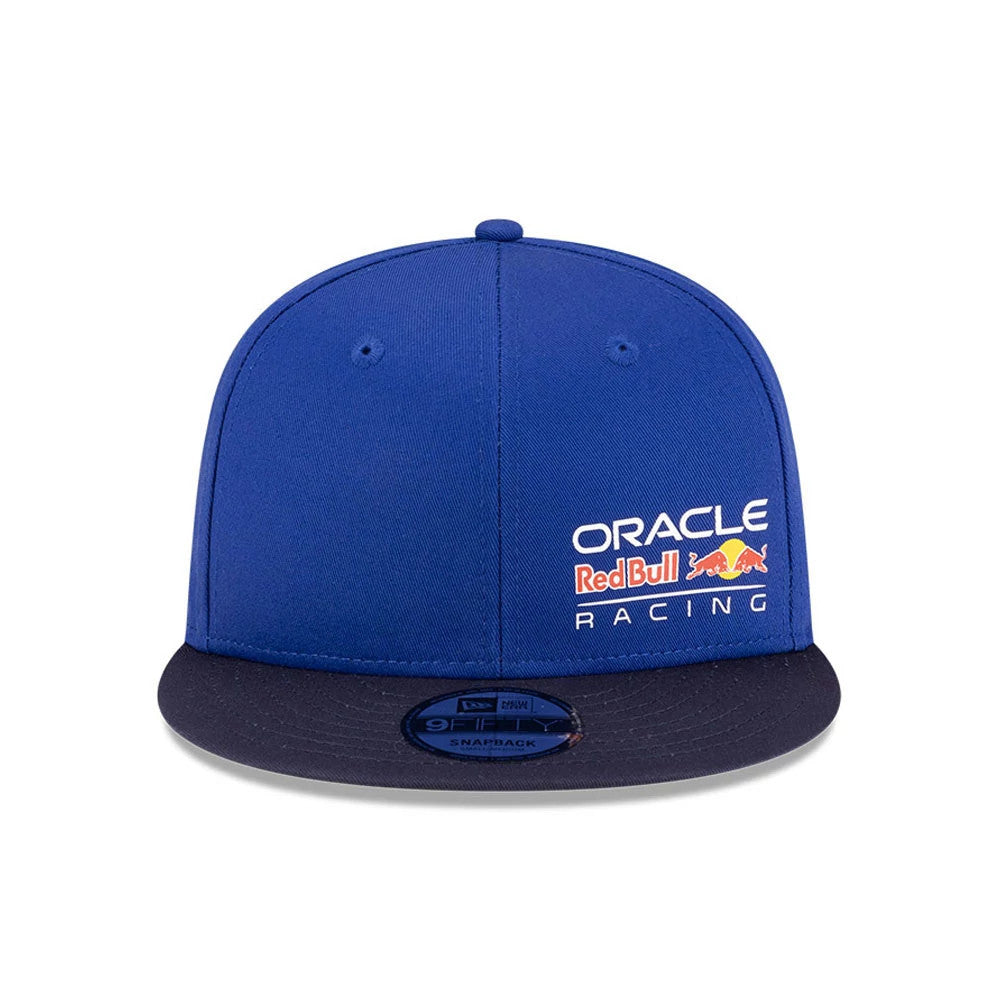 Red Bull Racing Essential Dark Blue New Era 9FIFTY Snapback Adjustable Cap, front view showing the white and red printed Oracle Red Bull Racing logo on the right front panel, with a flat dark blue visor and a 9FIFTY size sticker.