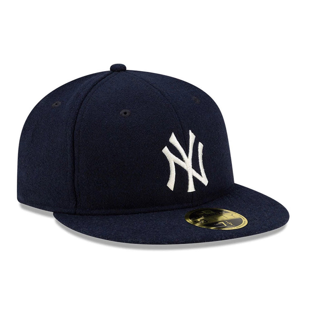 New York Yankees FOG X MLB Navy Retro Crown New Era 59FIFTY Fitted Cap, three-quarter view showing the raised white embroidered NY logo on the front panel, navy flat visor with a gold 59FIFTY size sticker, and navy top button.