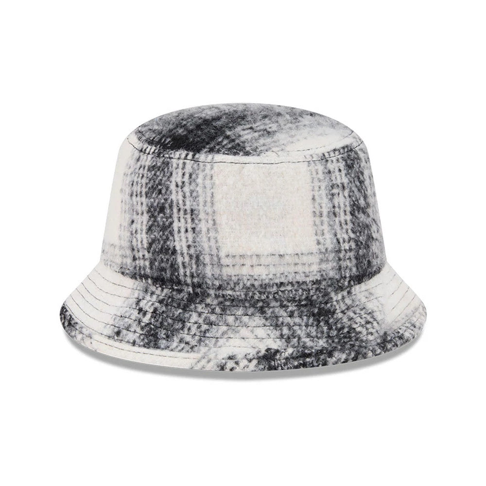 New Era White & Black Plaid Bucket Hat, front view with a soft fabric crown featuring a grey and black plaid pattern, and a gently sloping visor that matches the crown's design, creating a monochromatic look.