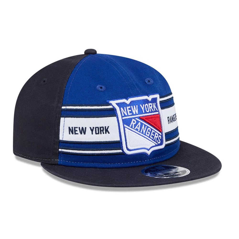 New York Rangers NHL Team Stripes Blue Retro Crown New Era 9FIFTY Adjustable Cap, three-quarter view showing the embroidered team logo on the front panel, set above navy and white striped with a curved navy visor and 9FIFTY size sticker.