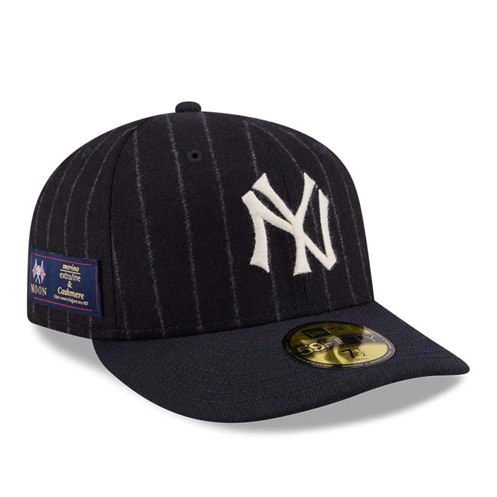 New York Yankees MLB X Moon Navy New Era 59FIFTY Fitted Cap, three-quarter view showing the white embroidered NY logo on the pinstriped navy front panels, a gold 59FIFTY size sticker on the flat visor, and a Moon fabric label on the left side.