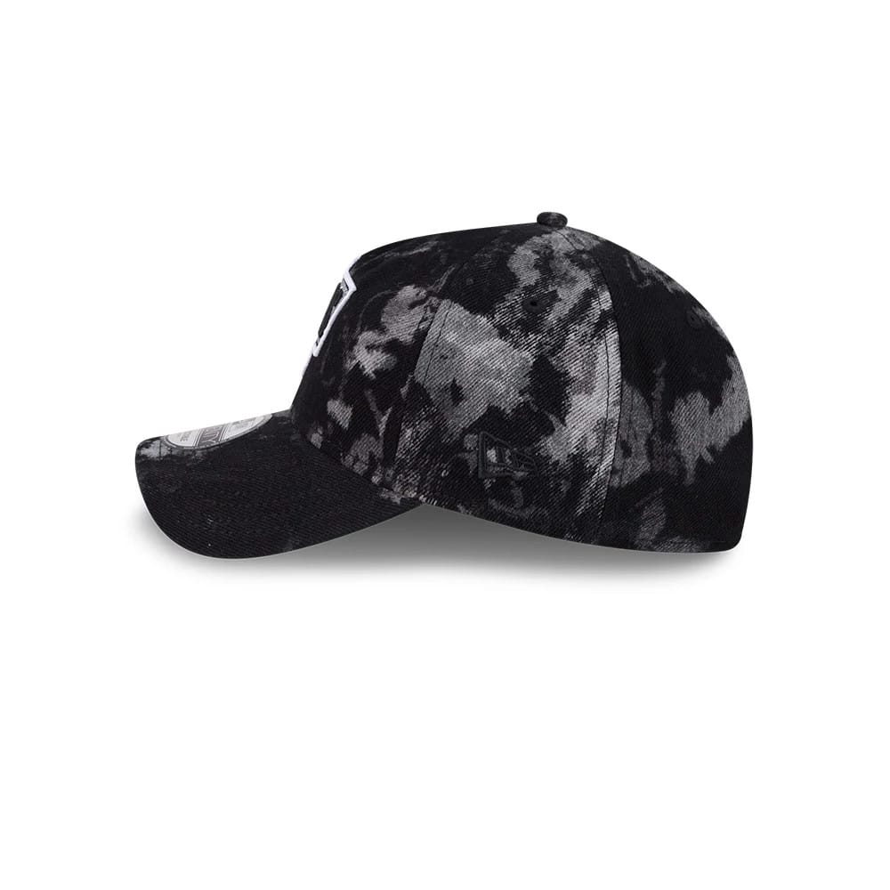 LA Kings NHL Bleached Denim Black New Era 9TWENTY A-Frame Adjustable Cap, side view showing the bleached black denim pattern, the white LA Kings logo on the front panel, and the embroidered New Era flag logo on the left side.