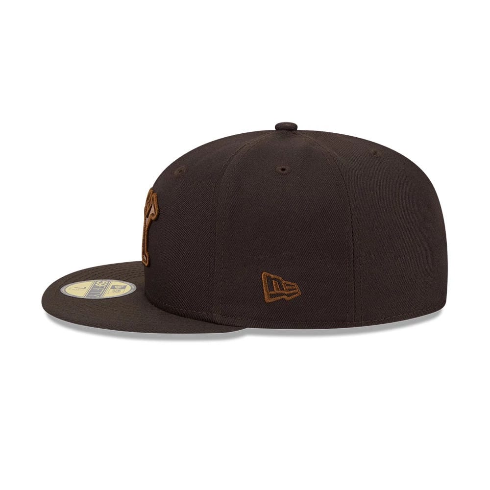 New York Black Yankees MLB Negro League Dark Brown New Era 59FIFTY Fitted Cap, side view showing the brown embroidered New Era flag logo on the left side of the structured dark brown crown and a gold 59FIFTY size sticker on the flat visor.