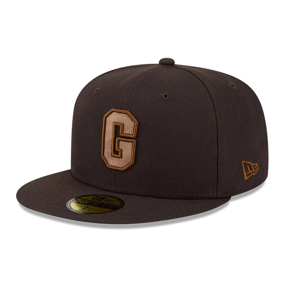 Homestead Grays MLB Negro League Dark Brown New Era 59FIFTY Fitted Cap, three-quarter view showing a raised brown embroidered G on the front panel, a flat brown visor with a gold 59FIFTY size sticker, and the New Era flag logo on the left side.