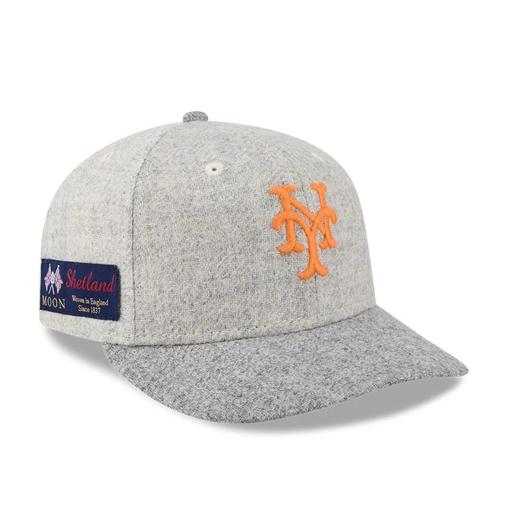 New York Mets MLB X Moon Light Beige New Era 59FIFTY Fitted Cap, three-quarter view showing the orange raised embroidered NY logo on the front panel, with a textured visor and a Shetland wool label on the left side.
