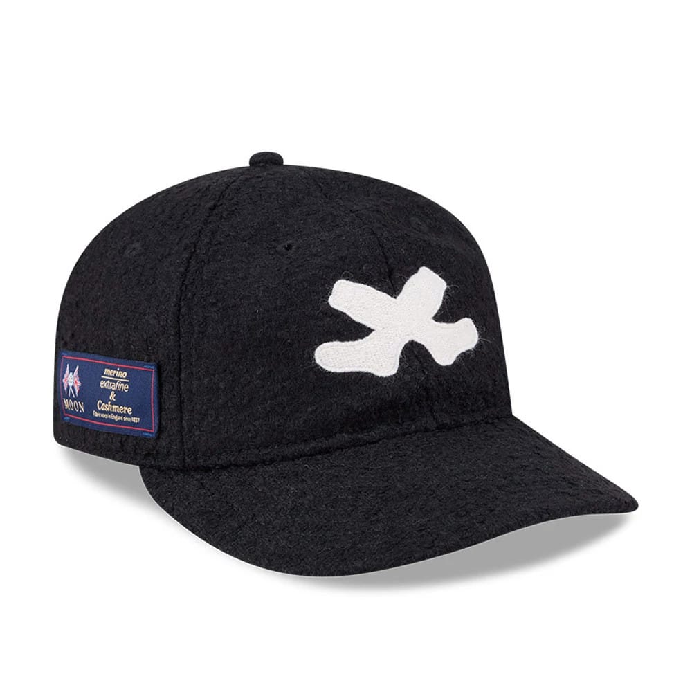 Chicago White Sox MLB X Moon Navy Retro Crown New Era 9FIFTY Adjustable Cap, three-quarter view showing a large white embroidered X on the front panel and a Moon merino label on the left side of the soft, dark navy crown.