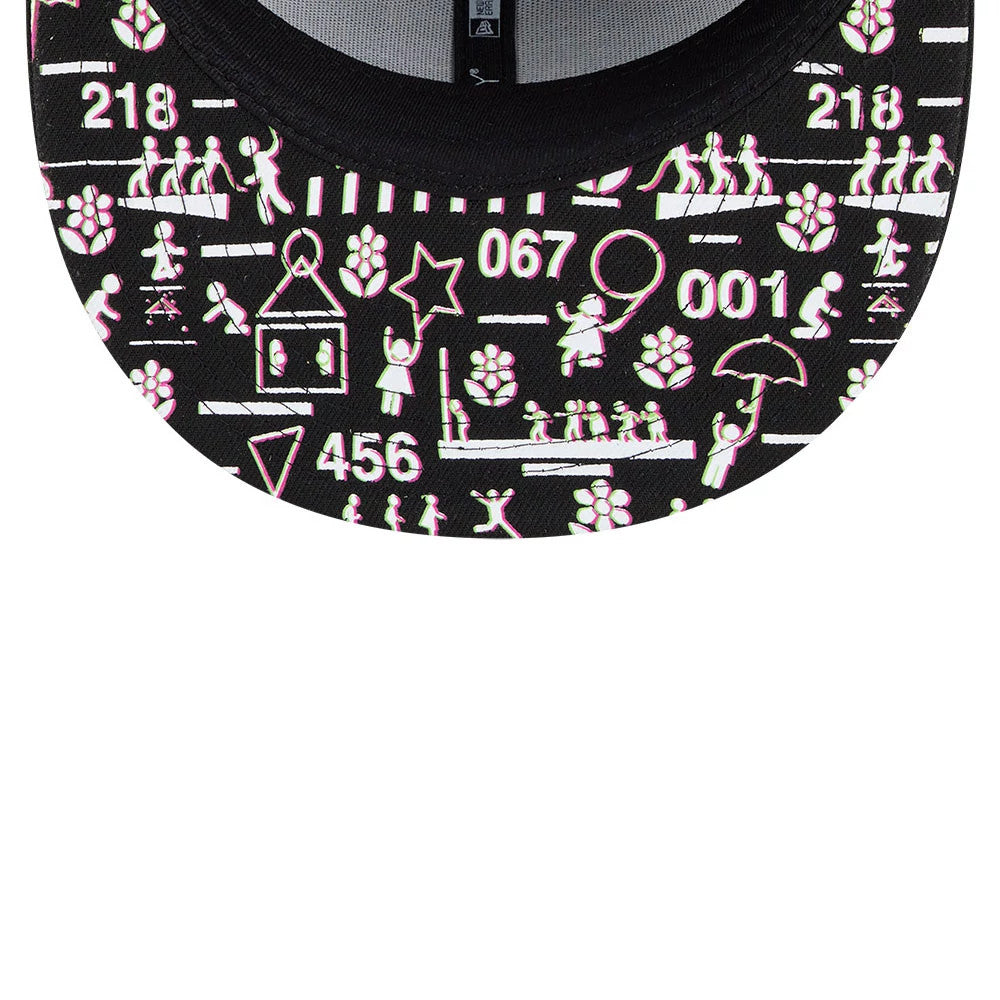 Netflix Squid Game Mask Black New Era 59FIFTY Fitted Cap, inside view showing the detailed pink and white Squid Game graphics on the black undervisor with black taping in the centre.