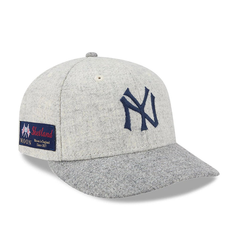 New York Yankees MLB X Moon Light Beige New Era 59FIFTY Fitted Cap, three-quarter view showing the navy NY logo in raised embroidery on the front panel, with a Shetland Moon woven patch on the left side and a grey textured visor.