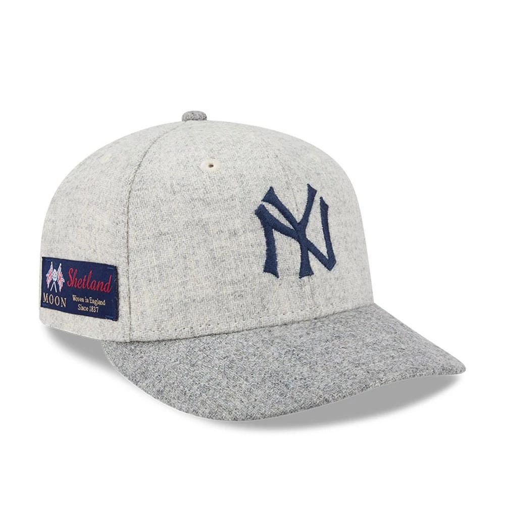 New York Yankees MLB X Moon Light Beige New Era 59FIFTY Fitted Cap, three-quarter view showing the navy NY logo in raised embroidery on the front panel, with a Shetland Moon woven patch on the left side and a grey textured visor.