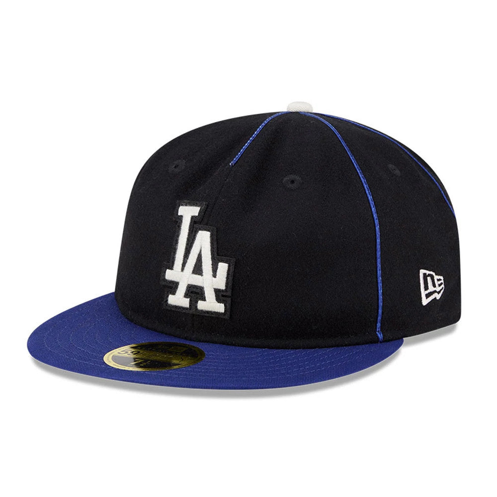 LA Dodgers MLB Felt Logo Dark Blue Retro Crown New Era 59FIFTY Fitted Cap, three-quarter view showing the raised white LA logo on the front panel, a blue flat visor with a gold 59FIFTY size sticker, and the New Era flag logo on the left side.
