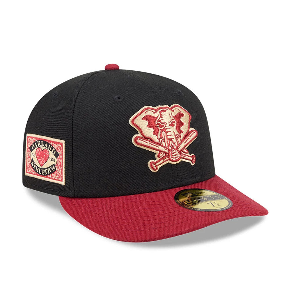 Athletics MLB Team Cards Black New Era 59FIFTY Fitted Cap, three-quarter view showing a beige embroidered elephant logo on the black front panel, a maroon flat visor with a gold 59FIFTY size sticker, and a side patch logo.