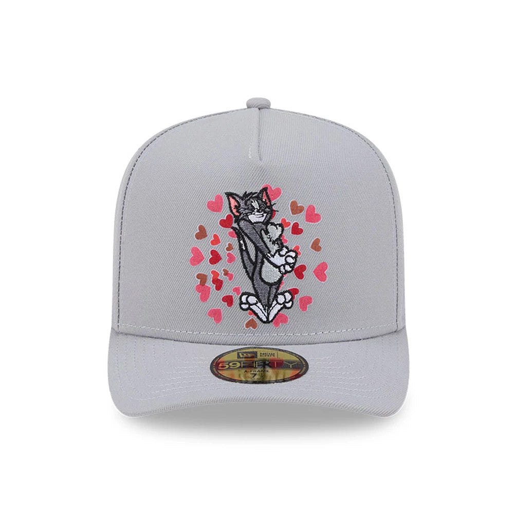 Tom & Jerry Love Struck Grey New Era 59FIFTY A-Frame Fitted Cap, front view showing embroidered graphic of cartoon cat surrounded by red and pink hearts on grey front panel, with a gold 59FIFTY size sticker on the matching grey visor.