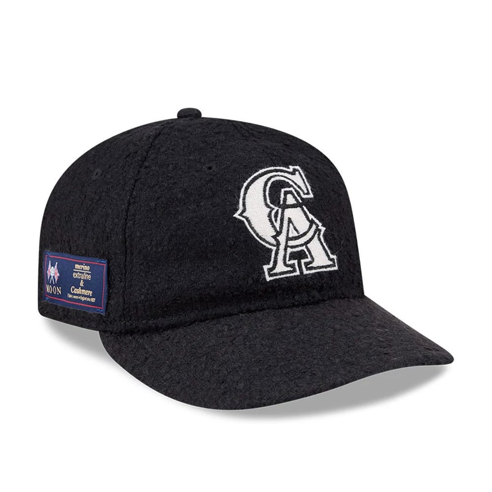 LA Angels MLB X Moon Navy Retro Crown New Era 9FIFTY Adjustable Cap, front view showing the prominent white embroidered CA logo on the front panel, with a patch on the left side and the textured navy fabric of the visor.