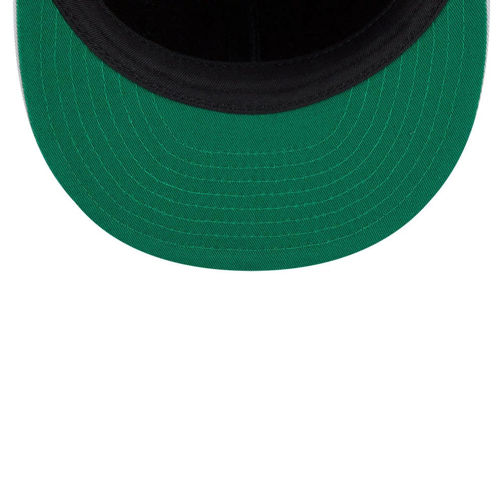 LA Kings NHL Felt Logo Black Retro Crown New Era 59FIFTY Fitted Cap, inside view showing a green undervisor contrasted against a black sweatband, with reinforced stitching along the curved edge for added durability and style.