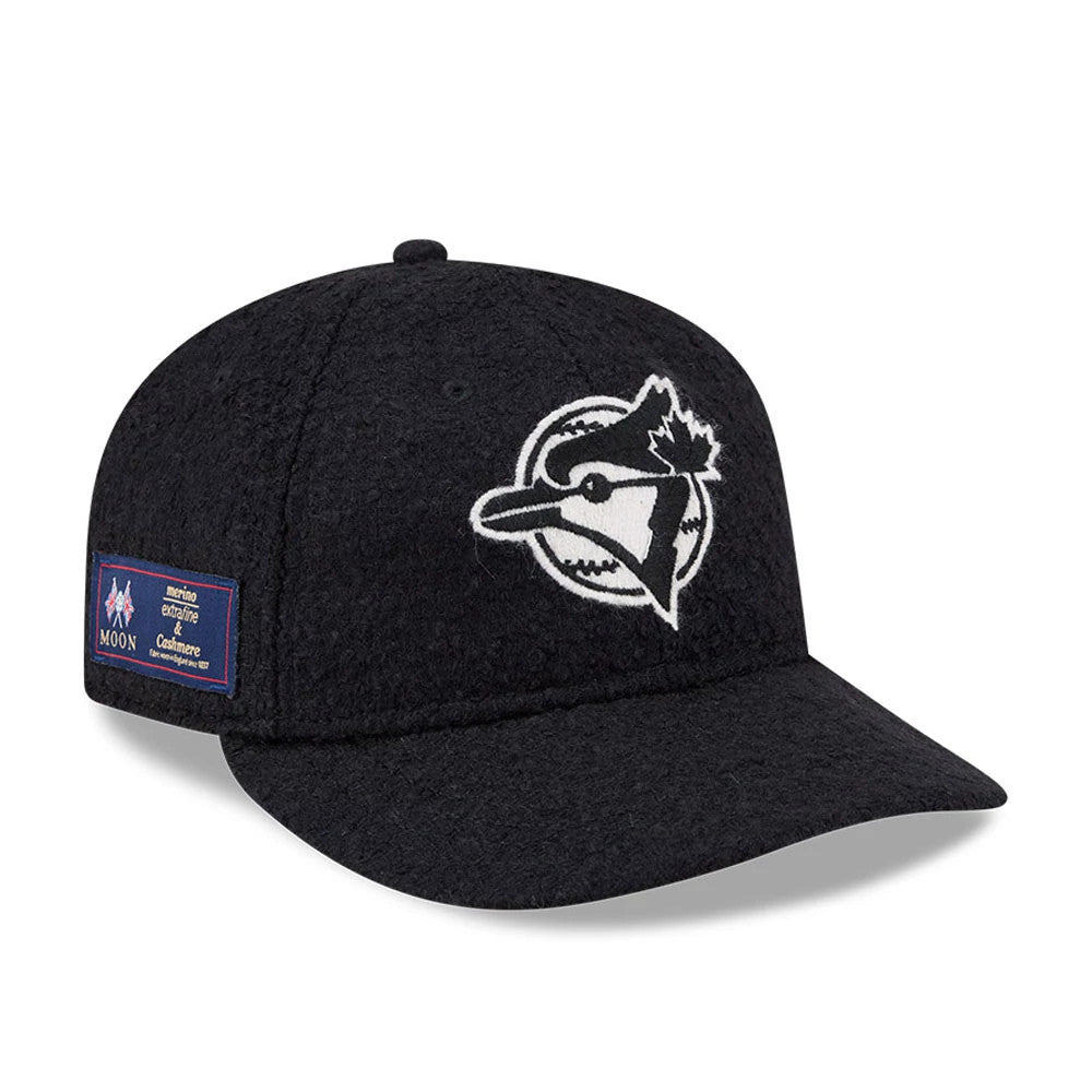 Toronto Blue Jays MLB X Moon Navy Retro Crown New Era 9FIFTY Adjustable Cap, three-quarter view showing the white and black embroidered Blue Jays logo on the front panel, navy textured fabric, and Moon brand patch on the left side.