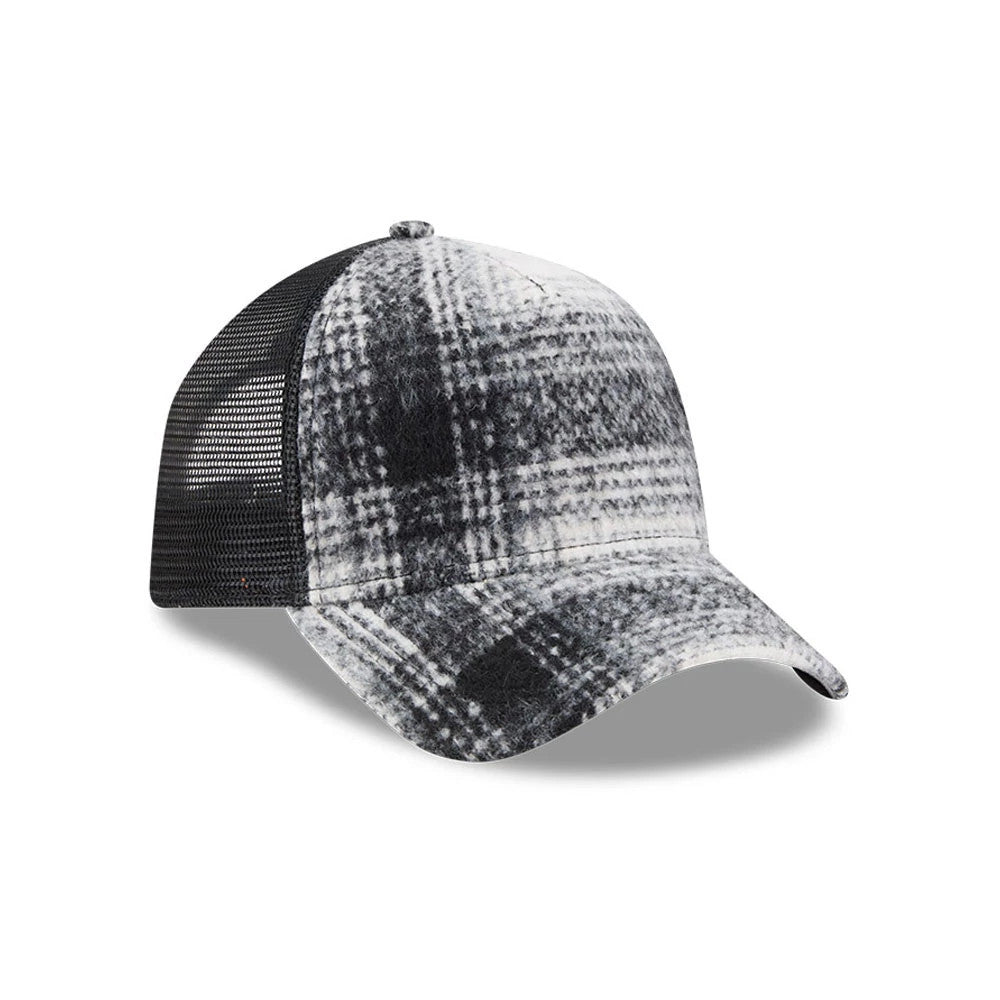 New Era White & Black Plaid 9FORTY A-Frame Trucker Adjustable Cap, three-quarter view showing the structured front panels with a plaid pattern, black mesh back panels, and a curved visor without a size sticker.