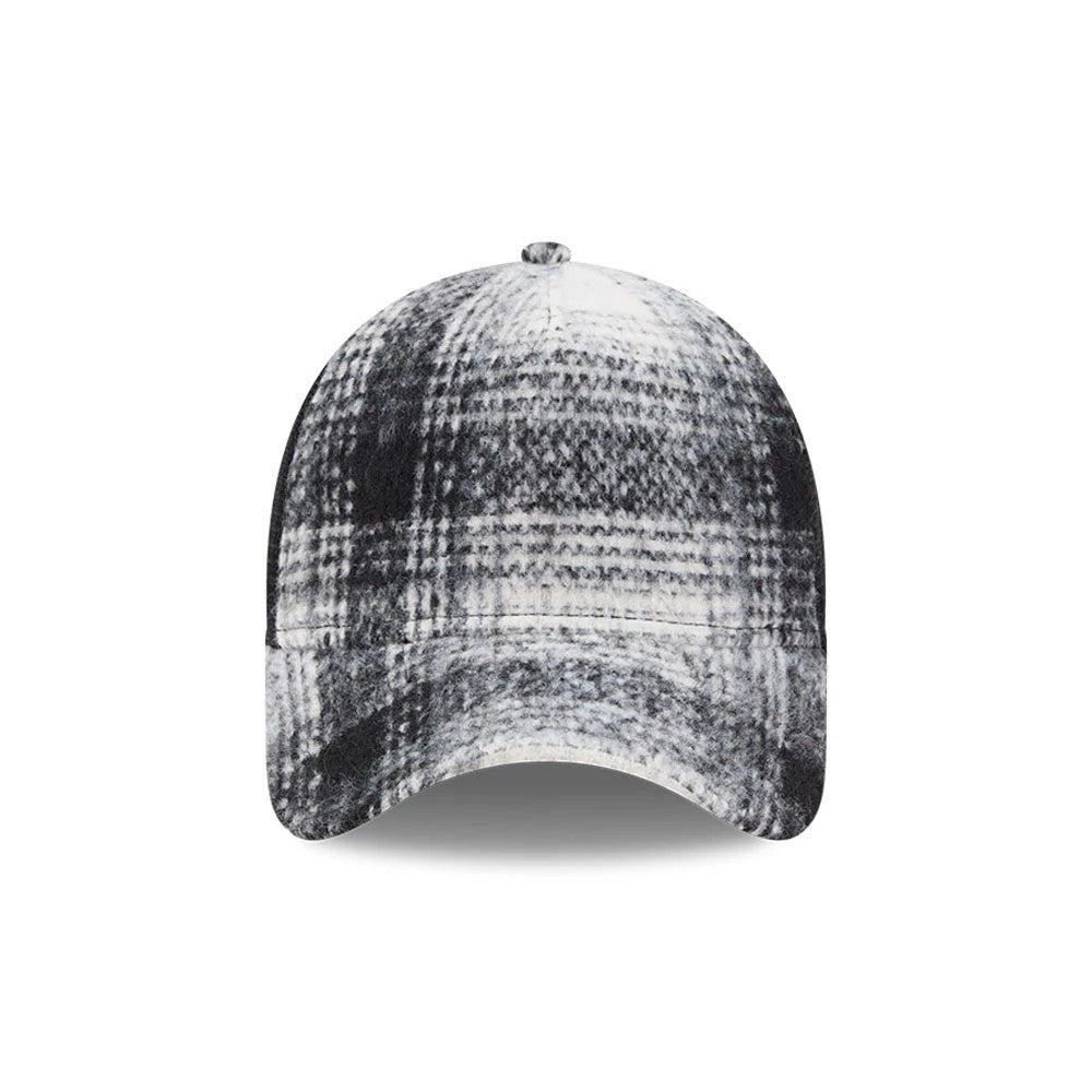 New Era White & Black Plaid 9FORTY A-Frame Trucker Adjustable Cap, front view showing the structured crown with a white and black plaid pattern, curved visor, and top button accentuating its modern design.