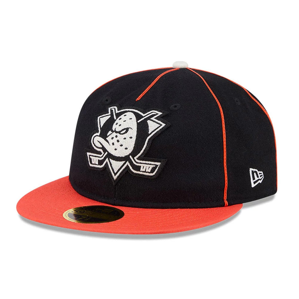 Anaheim Ducks NHL Felt Logo Black Retro Crown New Era 59FIFTY Fitted Cap, three-quarter view showing the felt logo with duck mask and hockey sticks on the front panel, a bright orange visor with a gold 59FIFTY size sticker.