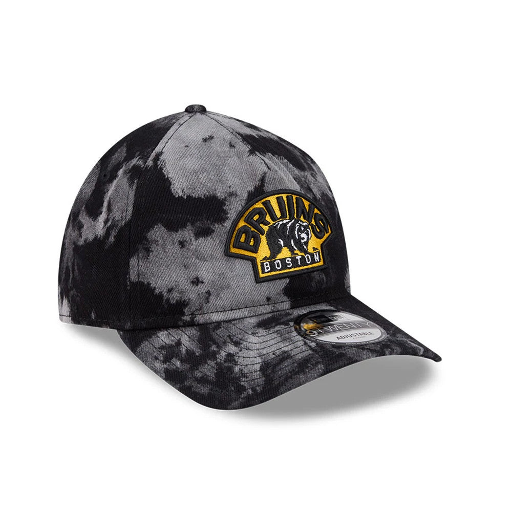 Boston Bruins NHL Bleached Denim Black New Era 9TWENTY A-Frame Adjustable Cap, three-quarter view showing the raised embroidered Bruins logo in gold and black on the front panel, curved bleached denim visor, and 9TWENTY size sticker on the top.