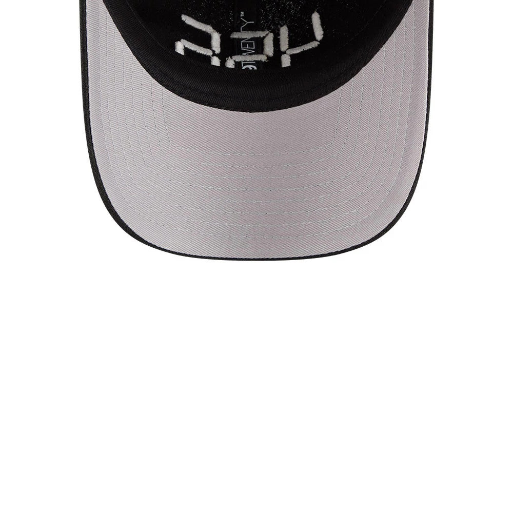Netflix Squid Game 456 Black New Era 9TWENTY Adjustable Cap, inside view showing the grey undervisor, white internal taping with graphic text, and black trim around the edge of the structured visor.