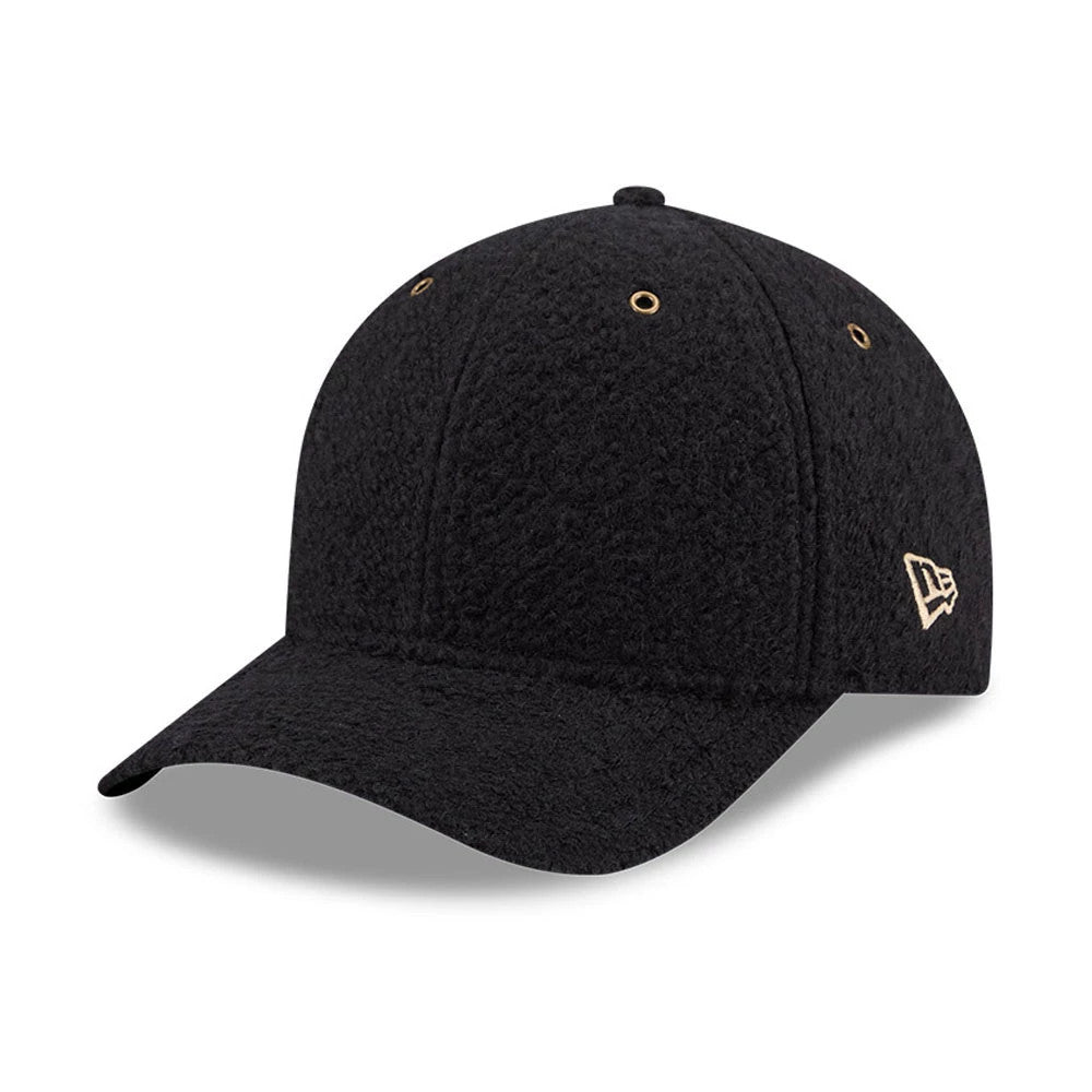 New Era Brushed Fleece Black New Era 9FORTY M-Crown Adjustable Cap, three-quarter view showing the gold New Era flag logo embroidered on the left side, with a textured black fleece fabric and matching eyelets on the structured crown.
