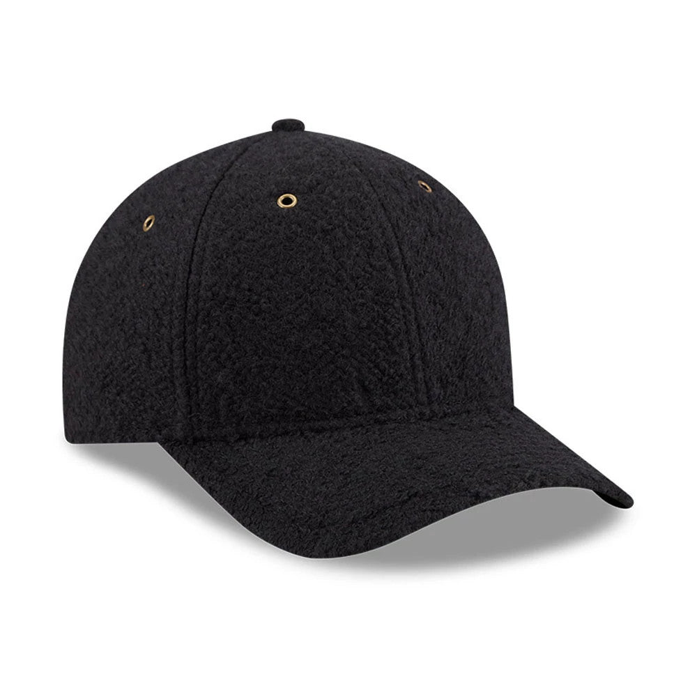 New Era Brushed Fleece Black 9FORTY M-Crown Adjustable Cap, three-quarter view showing the textured black fleece fabric with curved visor, gold eyelets on the structured crown and matching top button, creating a and modern appearance.