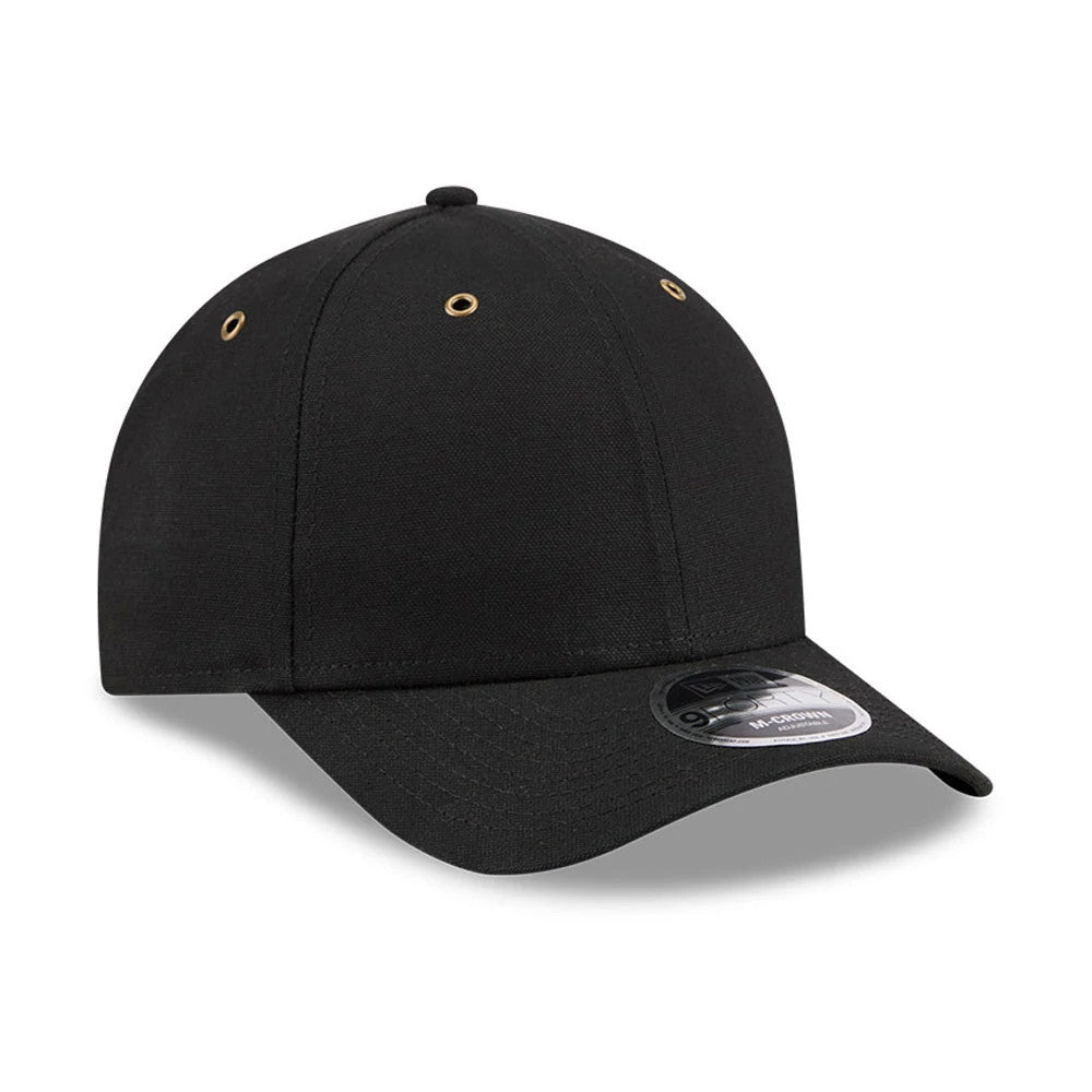New Era Premium Black 9FORTY M-Crown Adjustable Cap, three-quarter view showing gold embroidered eyelets on the structured black crown, with a curved black visor and a distinctive 9FORTY size sticker placed prominently at the front.