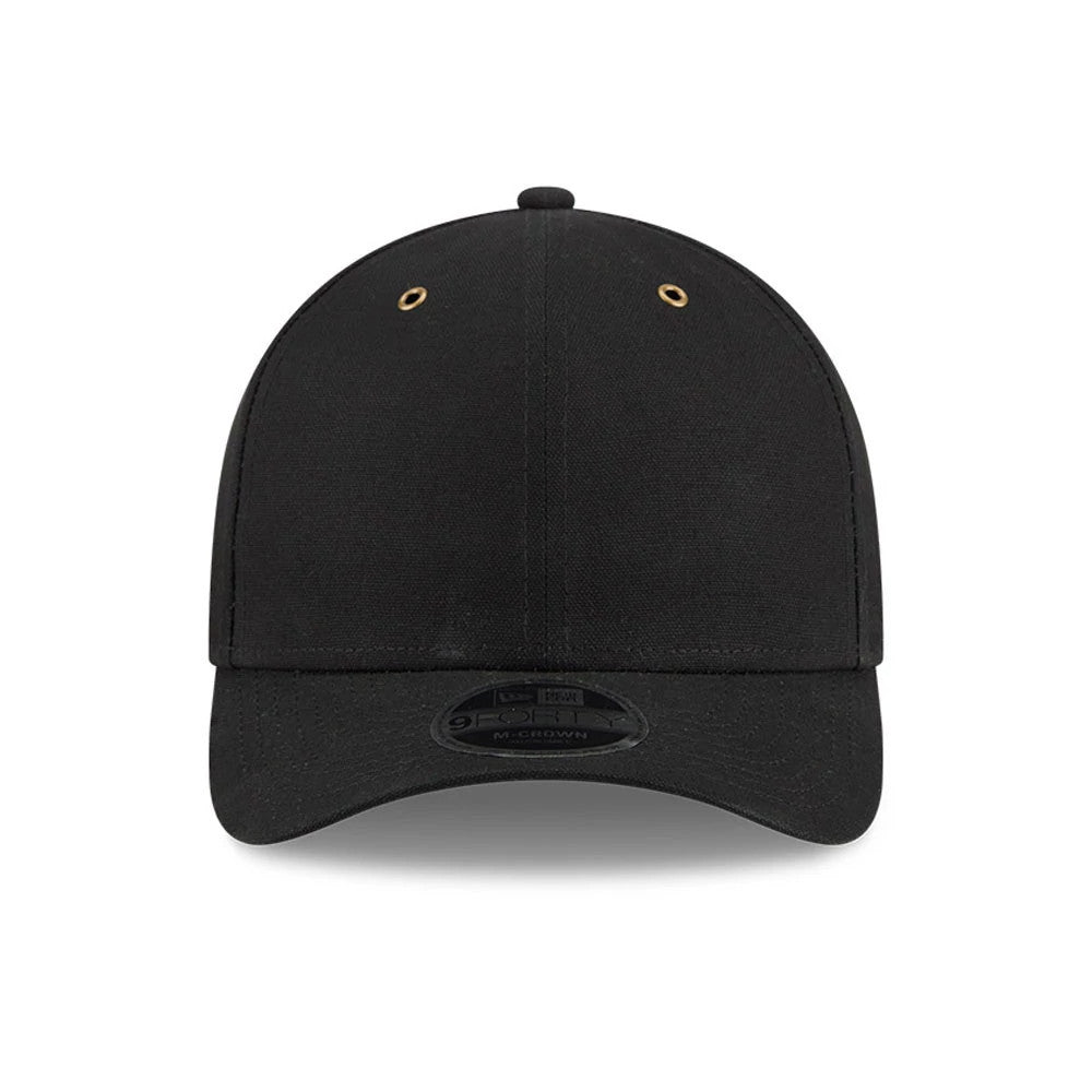 New Era Premium Black 9FORTY M-Crown Adjustable Cap, front view showing a simple black crown with two gold eyelets, a curved black visor, and a 9FORTY size sticker centred on the visor.