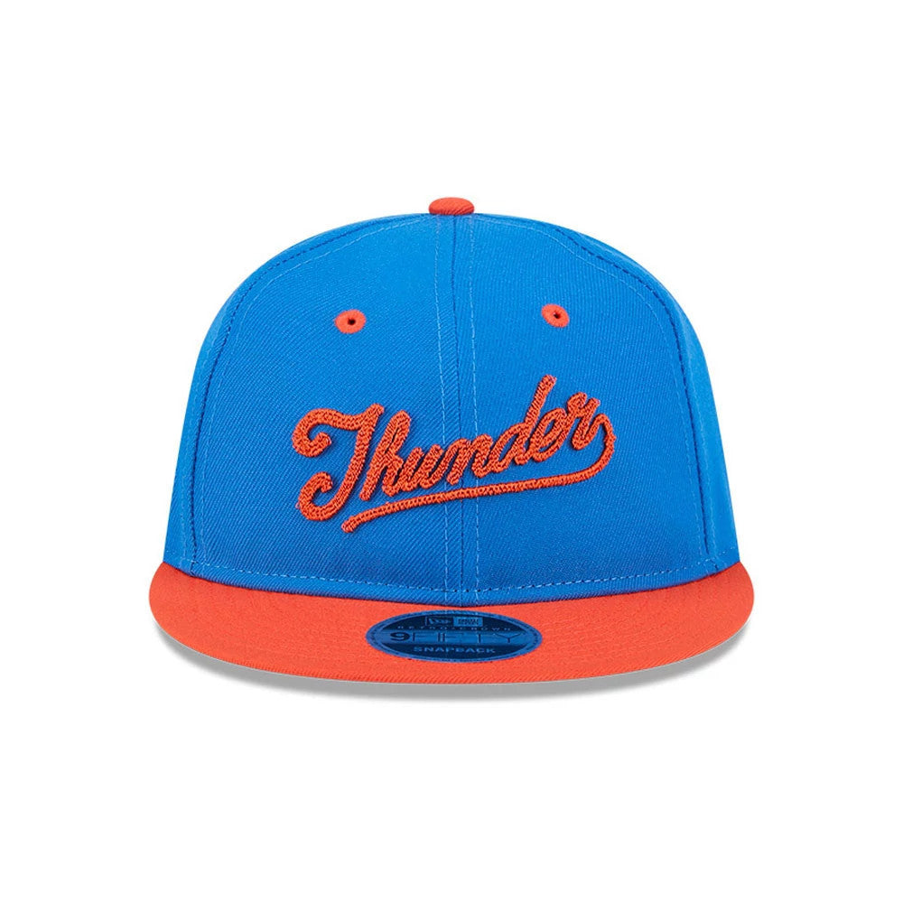 OKC Thunder NBA Chainstitch Script Blue Retro Crown New Era 9FIFTY Adjustable Cap, front view showing orange chainstitch script Thunder logo embroidered on the blue structured crown, contrasting bright orange flat visor, and blue 9FIFTY size sticker.
