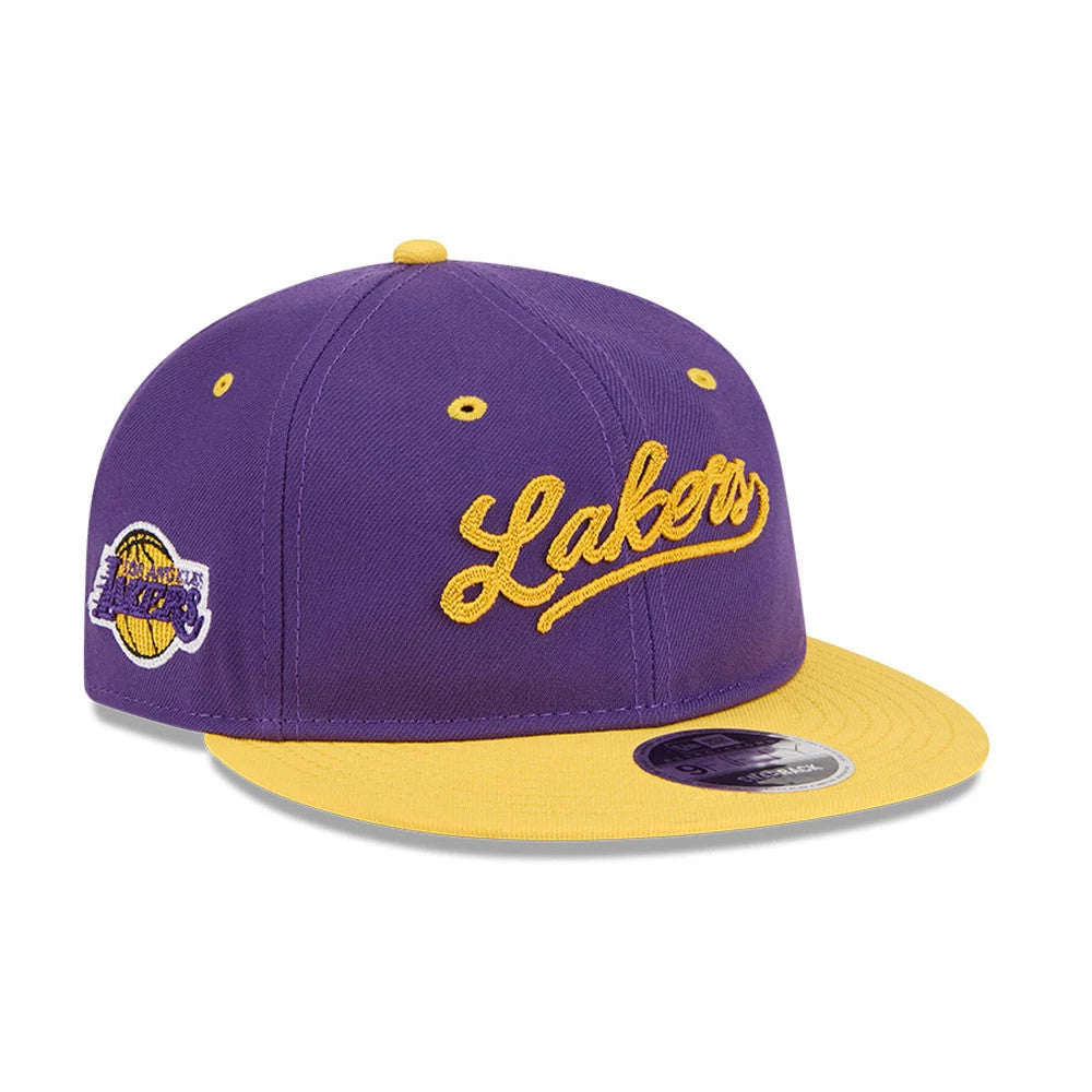 LA Lakers NBA Chainstitch Script Purple Retro Crown New Era 9FIFTY Adjustable Cap, three-quarter view showing the raised yellow Lakers script embroidered on the front panels, a contrasting yellow visor, and the LA Lakers logo patch on the left side.