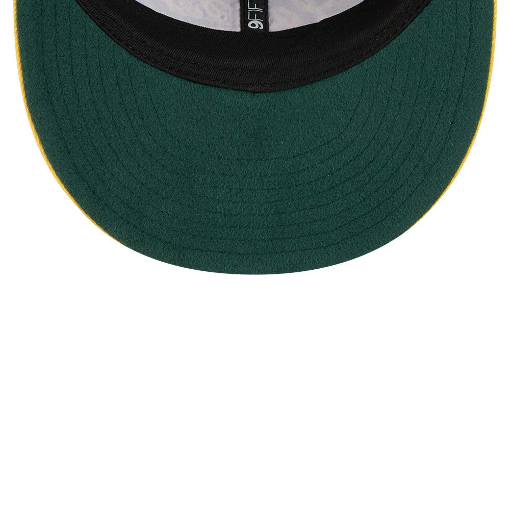 LA Lakers NBA Chainstitch Script Purple Retro Crown New Era 9FIFTY Adjustable Cap, inside view showing the green undervisor, black taping featuring a 9FIFTY label, and a contrasting yellow stitch along the visor edge.