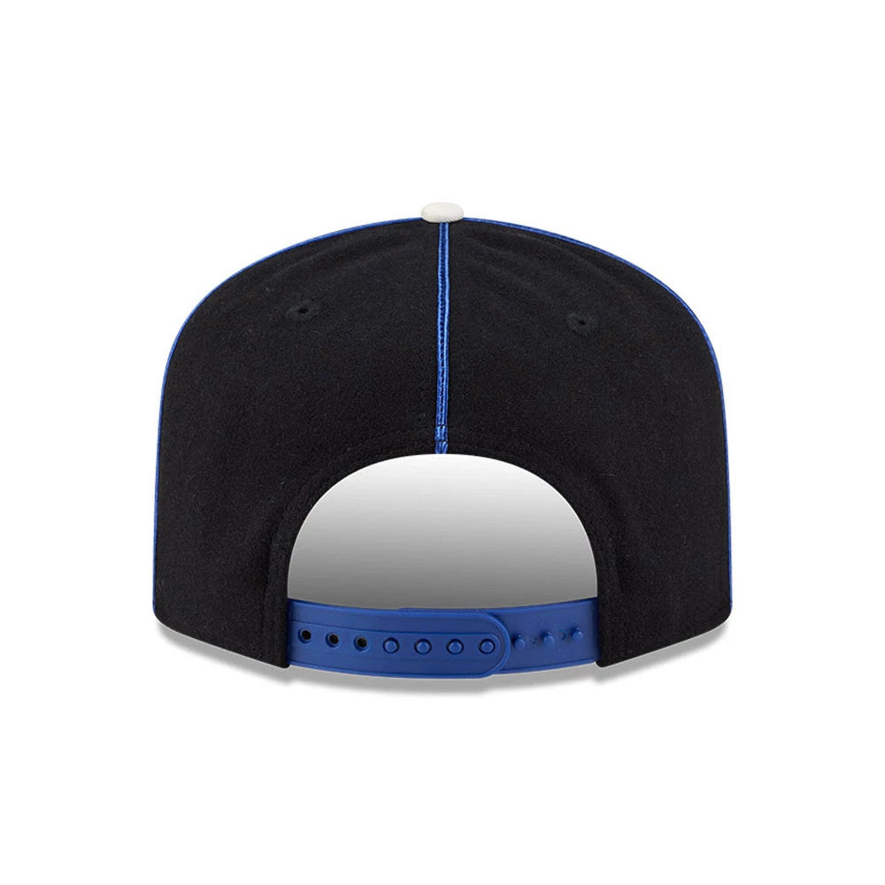 New York Rangers NHL Felt Logo Blue New Era 19TWENTY Adjustable Cap, rear view showing the cap's blue adjustable strap, a structured black crown with blue stitching along the panels, and a contrasting white top button.