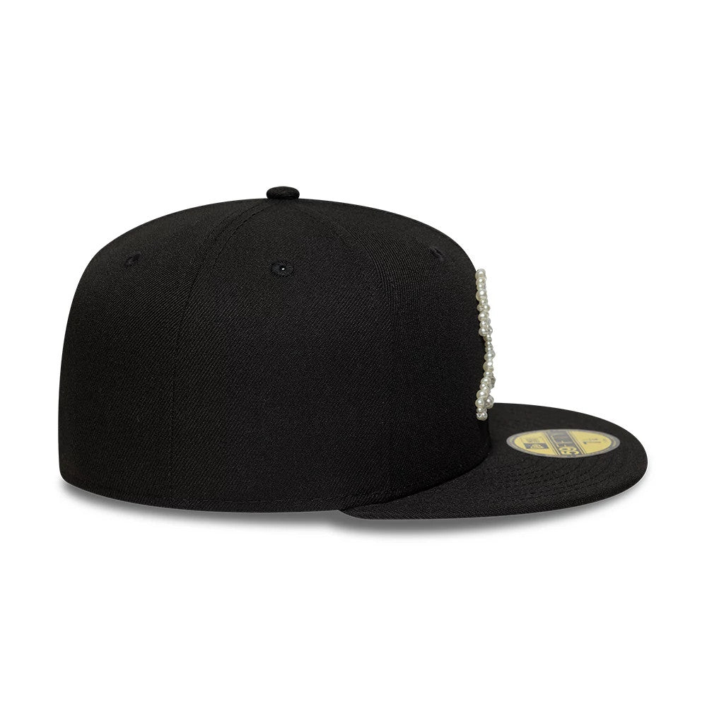 Athletics MLB Faux Pearl Black New Era 59FIFTY Fitted Cap, side view showing the structured black crown with a raised faux pearl embellished team logo on the front panel, paired with a flat black visor and a gold 59FIFTY size sticker.