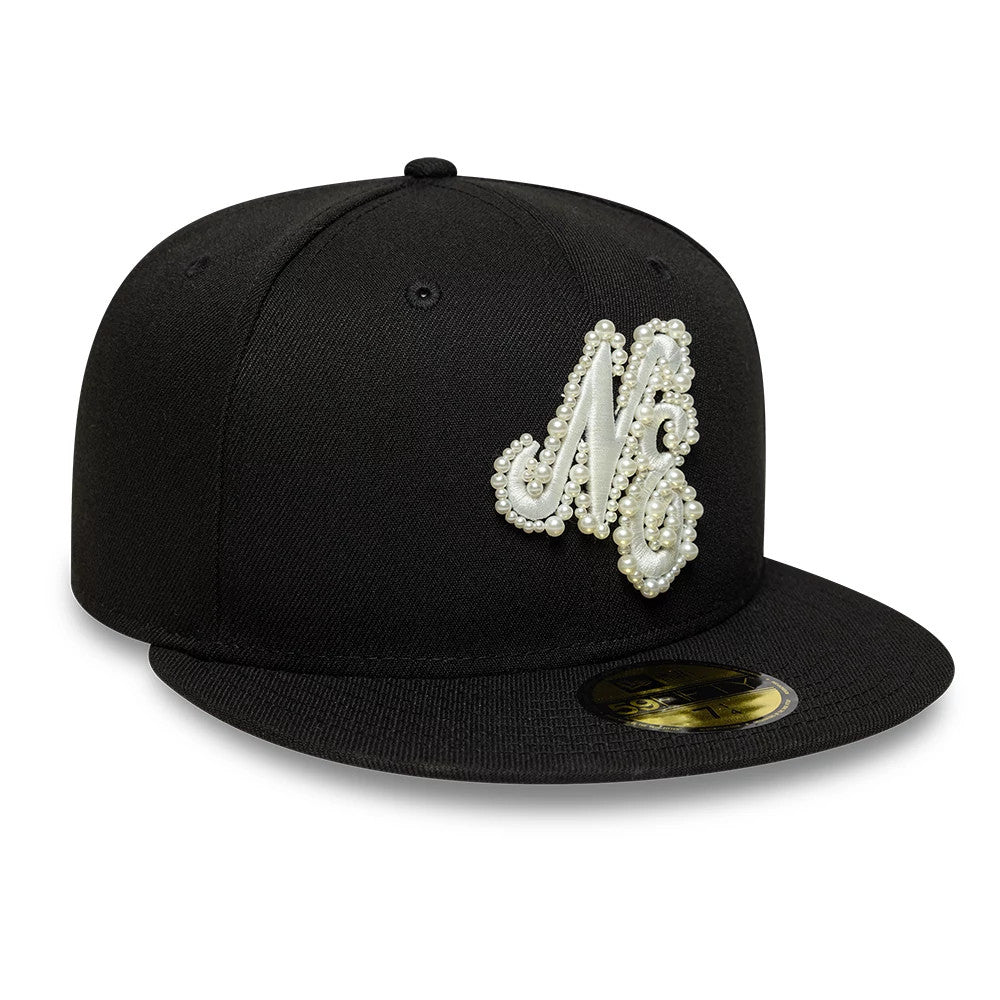 New Era Faux Pearl Black 59FIFTY Fitted Cap, front view showing an intricate white faux pearl embroidered NE logo on the front panel, a flat black visor with a classic gold 59FIFTY size sticker in the centre.