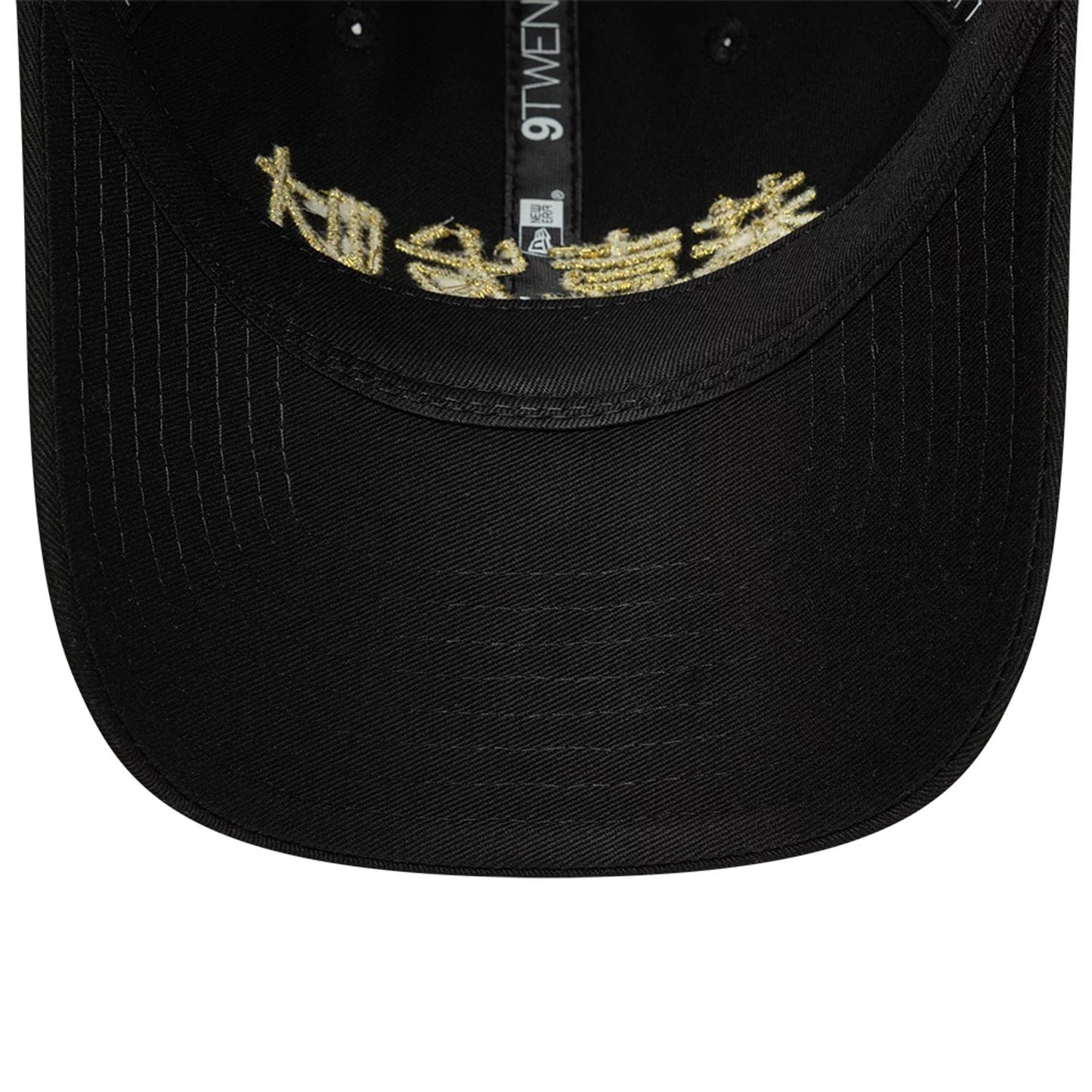 New Era Lunar New Year Black 9TWENTY Adjustable Cap, inside view showing gold embroidered characters on the black undervisor, with black taping running along the seams, and a 9TWENTY label on the inside crown.