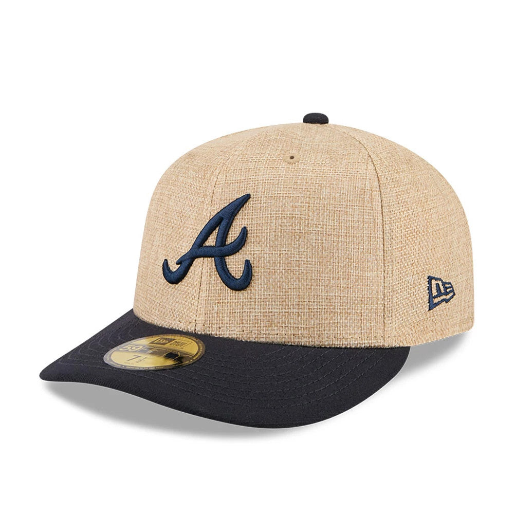 Atlanta Braves MLB Twine Beige New Era 59FIFTY Fitted Cap, three-quarter view showing the raised embroidered navy blue A logo on the front panel, contrasted by a black flat visor, and highlighted with a gold 59FIFTY size sticker.