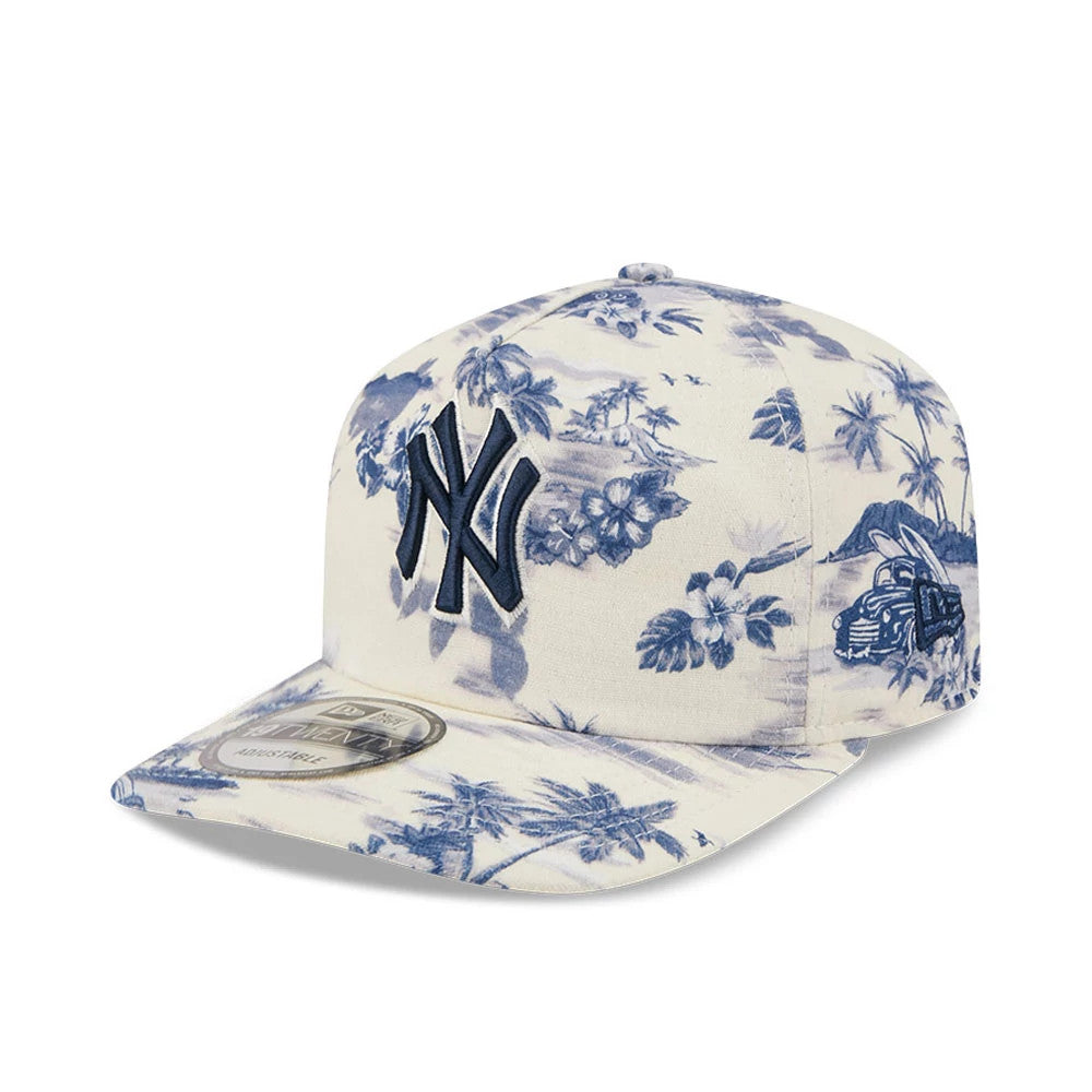 New York Yankees MLB Tropics Navy New Era 19TWENTY Adjustable Cap, three-quarter view showing the raised navy NY logo on the front panel, tropical graphics in blue across the white fabric, and a 19TWENTY size sticker on the floral-printed visor.