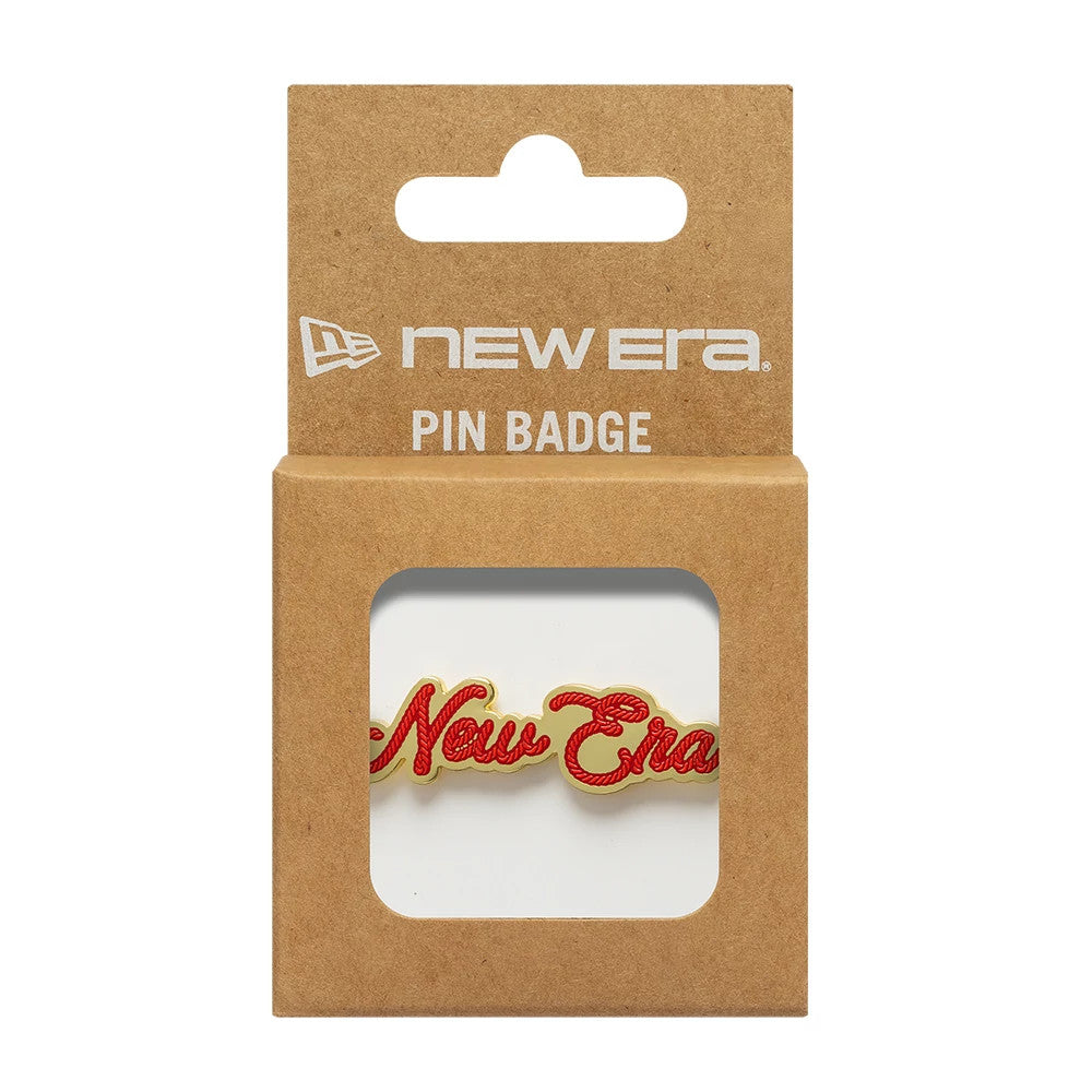New Era Lunar New Year Fan Red Pin Badge, front view showing the red embroidered New Era script logo with gold outline centred in a brown cardboard display with a cutout window, New Era branding and PIN BADGE text printed above.