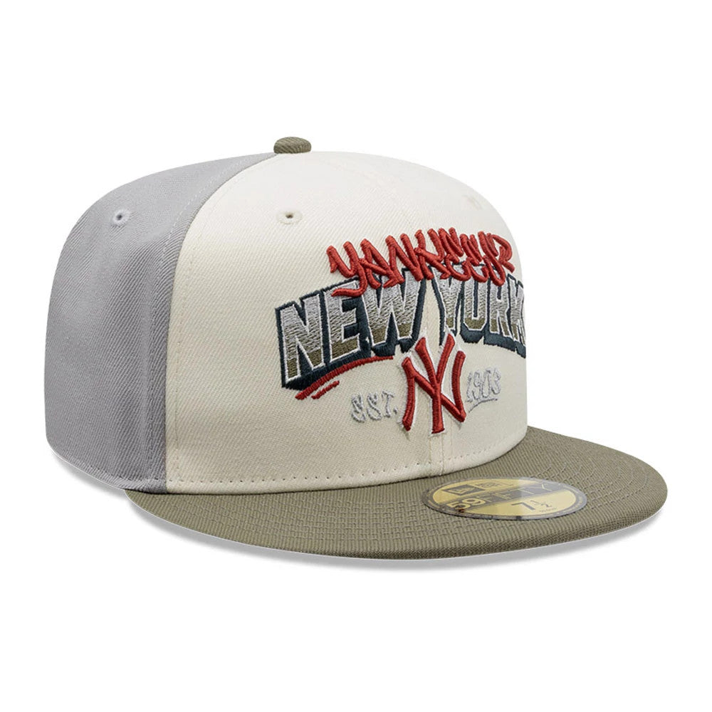 New York Yankees MLB Tagged Grey New Era 59FIFTY Fitted Cap, three-quarter view showing raised red graffiti-style Yankees script over dark embroidered New York lettering on the front panel, with a light khaki visor and a gold 59FIFTY size sticker.