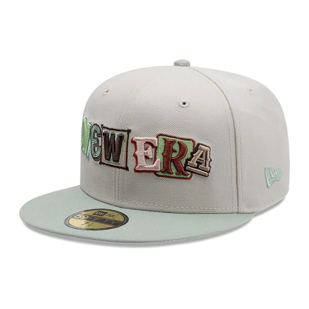 New Era DIY Note Light Beige New Era 59FIFTY Fitted Cap, three-quarter view showing colourful embroidered letters spelling 'NEW ERA' across the front panels, a matching light beige visor and a gold 59FIFTY size sticker on the visor.