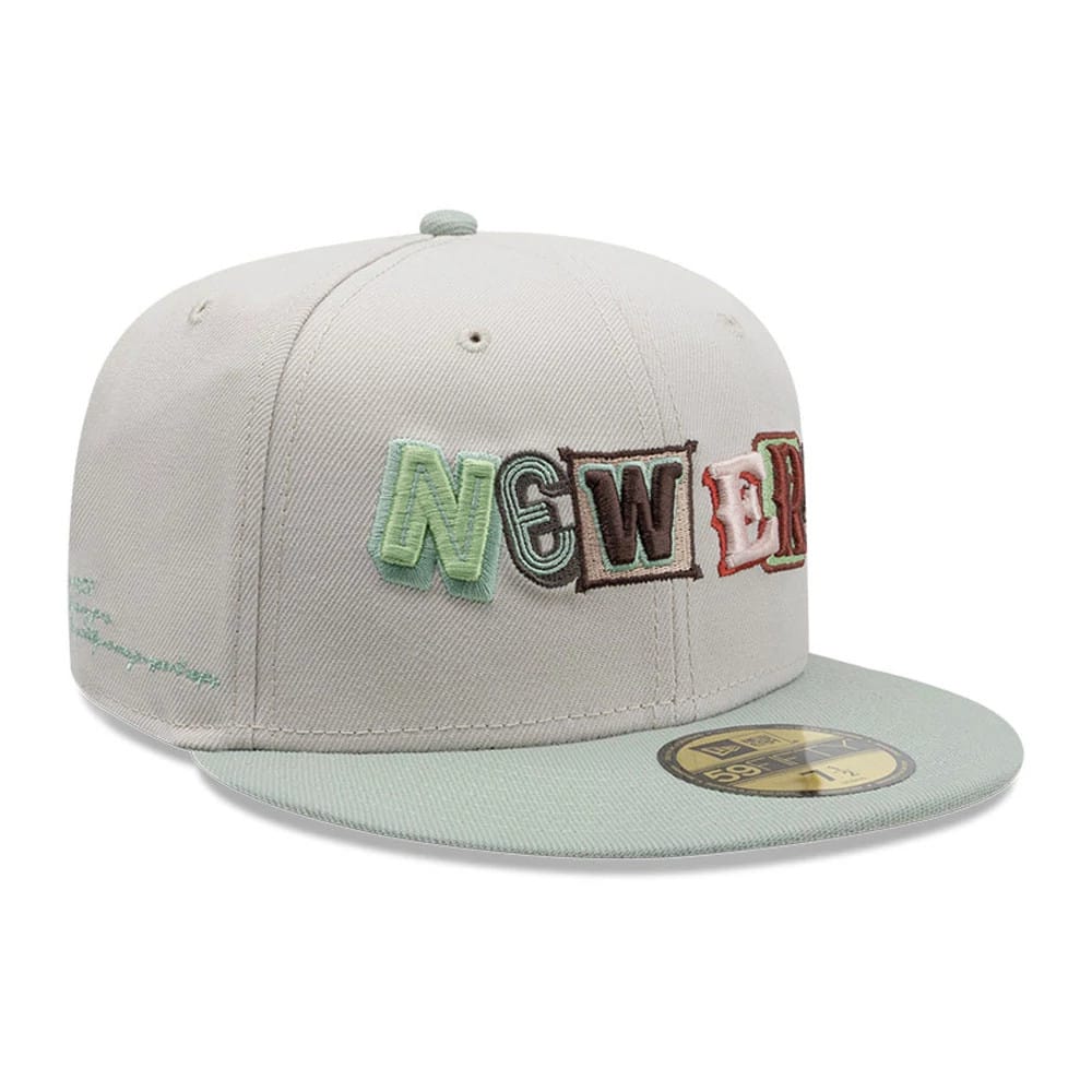 New Era DIY Note Light Beige 59FIFTY Fitted Cap, front view showing multicoloured raised embroidery of stacked letters spelling 'NEW ERA' on the front panel, with a light green visor and a gold 59FIFTY size sticker on the visor.
